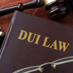 Law book that reads "DUI" on the front cover