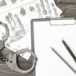 Hand cuffs and notepad for criminal prosecution