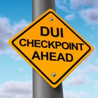 Sobriety and drunk driving checkpoint representing the dangers of drivers that are intoxicated above the legal limit by alcohol or other drugs while they are behind the wheel of a vehicle